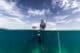 Girl with a fishing spear in a boat. Foto van The Water People Expedition