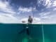 Girl with a fishing spear in a boat. Foto van The Water People Expedition